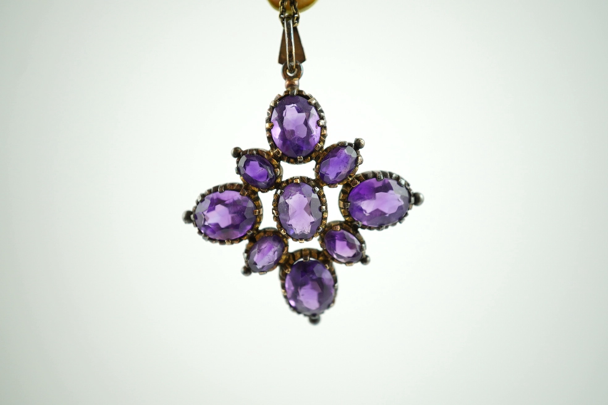 An amethyst pendant, 40mm, on a 9ct gold chain. Condition - fair